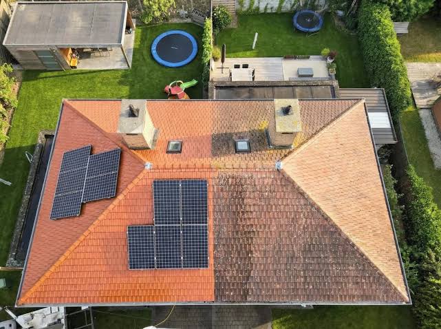Luchtfoto van een Nederlandse woning: links een schoon rood pannendak met zonnepanelen, rechts een vuil dak bedekt met mos en algen